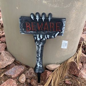 Hand holding BEWARE sign Halloween prop sign decor